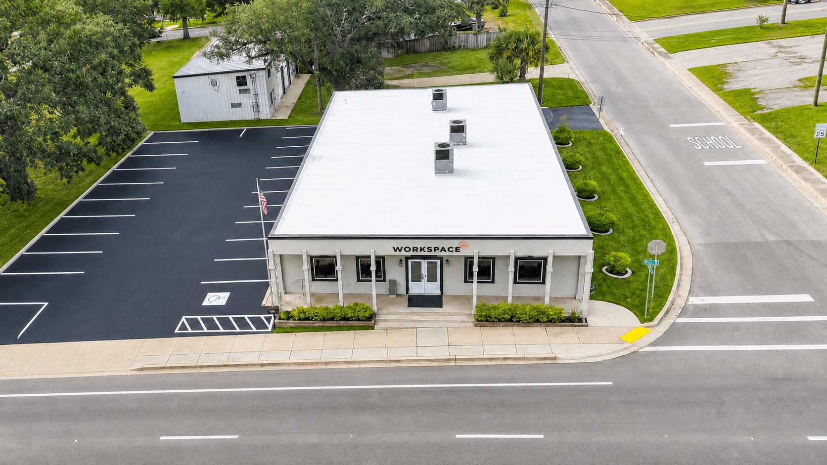 Aerial view of WorkSpace225 at 225 N Pace Blvd in Pensacola, Florida, with parking and branded entrance